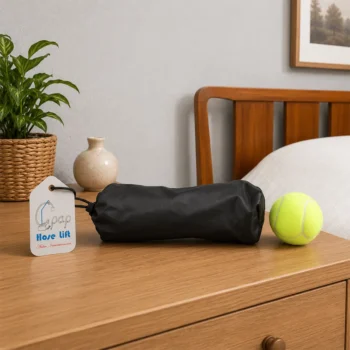 CPAP hose lift device in black pouch on nightstand